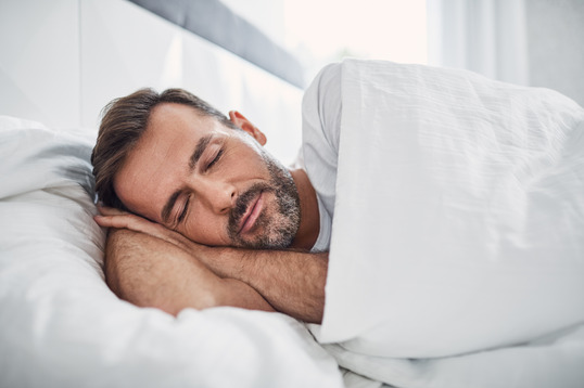 man sleeping on bed 